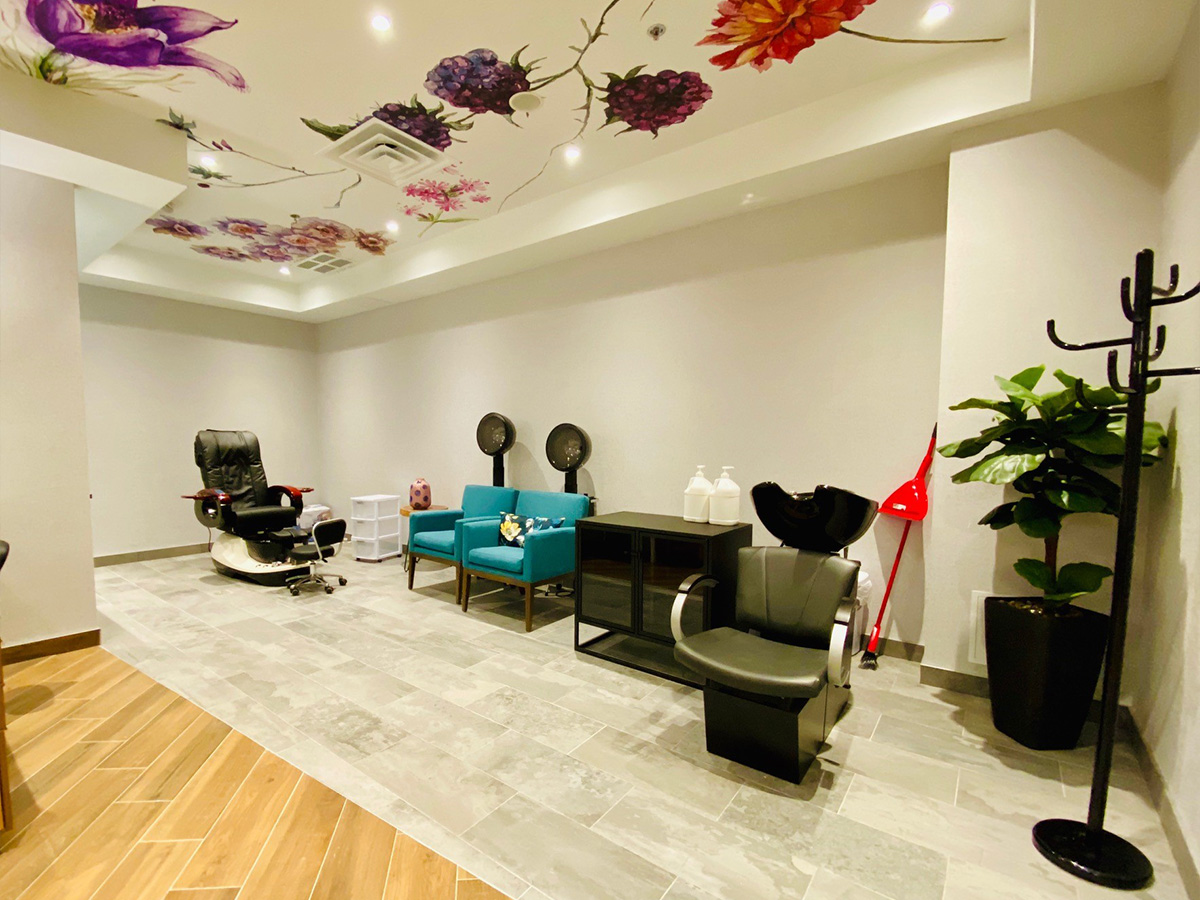 Relaxing spa salon with styling chairs, soft lighting, and elegant finishes.